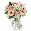 A gentle display of floral artistry sits poised in a clear glass vase, reminiscent of the welcoming window displays along Redbridge's vibrant avenues. Plush peach-toned roses, with their unfurling petals, are nestled at the bouquet's core, their touch conjuring sentiments of admiration and romantic thoughtfulness so often celebrated within the local community. Vibrant peach gerbera daisies, defined by soft petals radiating from deep brown centers, lend a spirited touch-like sunlight over Wanstead Park on a crisp morning. Interwoven among these blooms are puffs of feathery white baby's breath, each cluster lending a whisper-light texture that enhances the dreamy atmosphere, while classic white daisy chrysanthemums with luminous green centers peek through, infusing the arrangement with lively freshness. Subtle hints of deep green eucalyptus peek out between flowers, inspiring notions of renewal and calm. The foundation is an elegantly sculpted glass vase, clear and gently ribbed, revealing verdant stems and crystal water-evidence of meticulous preparation by the local florist. Softly tied around the neck, a natural raffia ribbon holds a simple white tag, ready for a hand-written note of affection. Bathed in clear light, this bouquet's pastel palette glows softly, making it an ideal gesture for sending love, extending comfort, or celebrating meaningful occasions across Redbridge. Every element, from bloom to bow, reflects the careful attention to freshness and aesthetic harmony offered by Redbridge Florist.